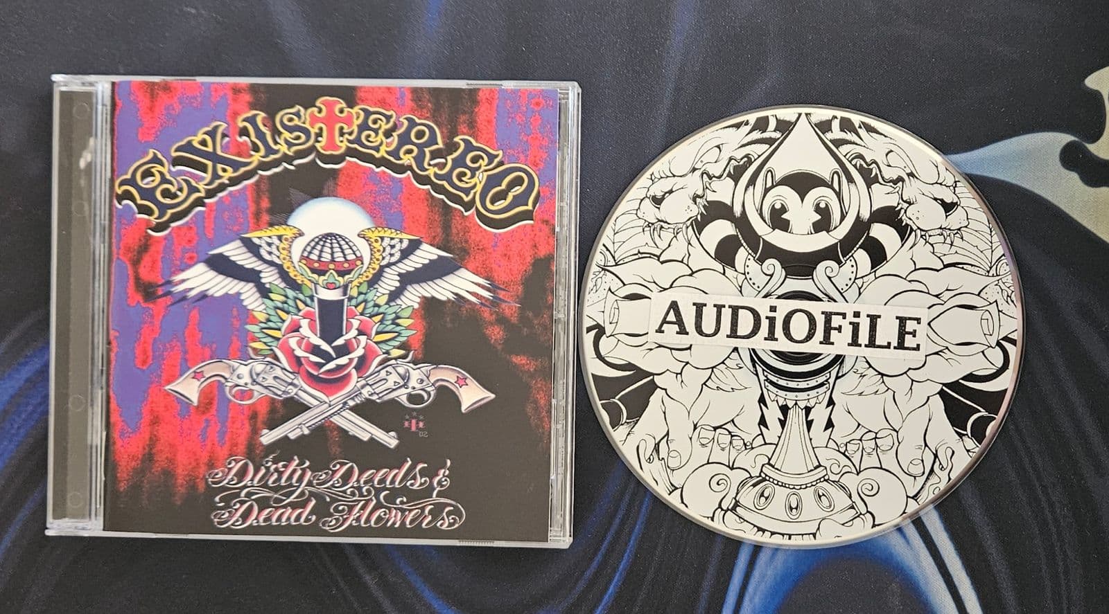 Existereo-Dirty_Deeds_And_Dead_Flowers-CD-FLAC-2003-AUDiOFiLE